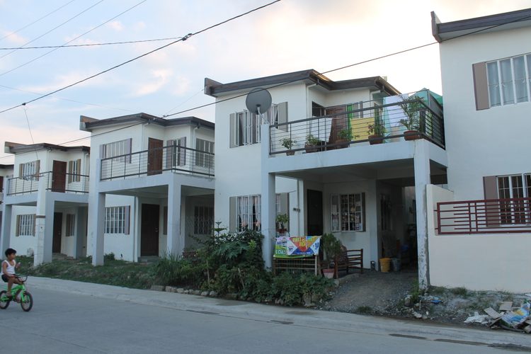 Typical gated subdivision street with two-story houses in the Philippines