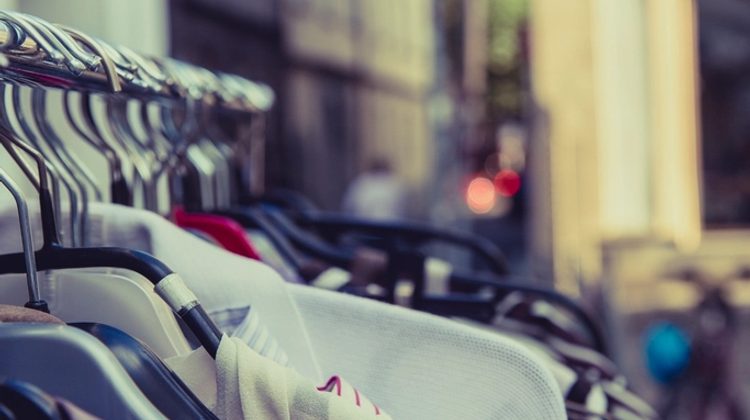 Rack of secondhand clothes on hangers